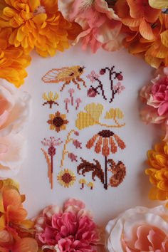 A finished cross stitch of a small, yellow, orange, and brown sampler. It features an adult yellow cicada, a cicada shell on an orange black-eyed susan flower, pink strawberries, various pink and yellow flowers, and yellow ginkgo leaves. Cottagecore Cross Stitch Pattern, Orange Cross Stitch, Yarn Hobbies, Golden Hour Nature, Summer Cross Stitch, Embroidery Things, Flowers Cross Stitch, String Crafts, Ginkgo Leaves