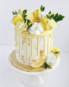 a white cake with lemons and flowers on top