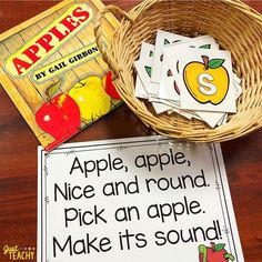 a basket with apples and cards on top of it next to an apple themed book