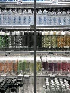 an assortment of sodas and water bottles on display