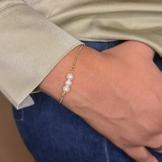 A delicate and timeless piece that combines the natural beauty of freshwater pearls with the modern sophistication of a dainty box chain. This bracelet features three beautiful freshwater pearls, each carefully selected for its lustrous glow, and is enhanced with two sparkling cubic zirconia stones for an extra touch of sparkle. The slider closure allows for an adjustable fit, making it easy to put on by yourself and ensuring the bracelet sits comfortably on your wrist. Available in both sterlin Dainty Pearl Drop Chain Bracelet, Elegant Pearl Drop Chain Bracelet, Elegant Everyday Chain Bracelet With Pearl Drop, Elegant Pearl Drop Chain Bracelet For Everyday, Elegant Sterling Silver Hypoallergenic Pearl Bracelet, Sterling Silver Pearl Chain Bracelet, Elegant Everyday Pearl Bracelet With Adjustable Chain, Pearl Bracelet Gold, Box Chain