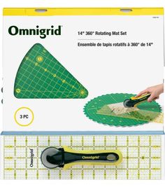 a pair of scissors sitting on top of a piece of green cutting paper next to a ruler