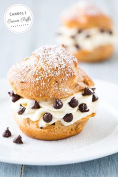 two chocolate chip cookies and cream sandwich on a white plate with the words cannoli cream cafe