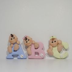 three little baby bears sitting next to each other on top of the letters b, c, and e