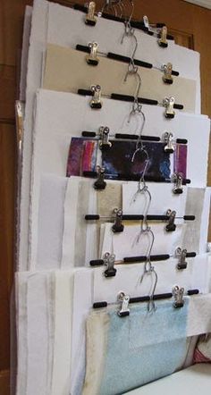 a wall hanging on the side of a door with several pieces of fabric attached to it