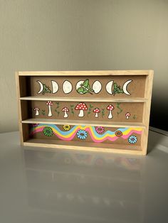 a wooden shelf with different designs on it