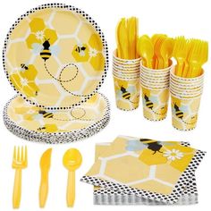 a set of yellow and black tableware with honeybees on the plates, forks, napkins, and utensils