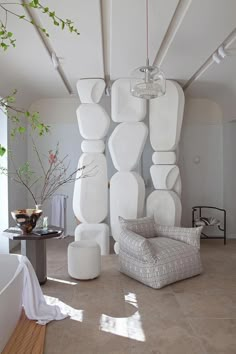 a living room filled with lots of white furniture