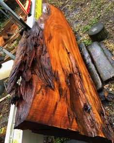 a large piece of wood sitting on top of a wooden bench