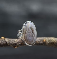 ♦Special Features: This ring features my not so wide bubble band and a beautiful Botswana agate. The band is full of texture and my granulation and a nice soft patina highlighting the textures. The stone is really something else. I admit to having a weakness for banded agates and this one has the most beautiful translucency to the banding. You can see how ribbon like each layer is and sort of watch it go down into the stone. These are a delight to examine and the coloring is a perfectly neutral Bohemian Agate Ring With Large Stone, Handmade Agate Rings In Nature-inspired Style, Agate Cabochon Rings For Healing, Oval Agate Rings For Healing, Handmade Agate Rings With Nature-inspired Style, Bohemian Oval Agate Rings, Artisan Rings With Agate And Natural Stones, Bohemian Rings With Natural Agate Stones, Artisan Agate Rings With Natural Stones