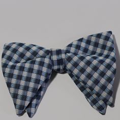 Vintage blue check bowtie in great condition. White, light, and dark blue in a smooth woven fabric. The color makes it especially perfect for winter, spring, and summer looks. In good, very lightly used condition. The fabric doesn't show any stains, rips, tears, or thinning. Blue Bow Ties For Business, Blue Bow Tie For Business, Blue Suit And Tie Accessories With Bow For Business, Classic Blue Tie With Butterfly Knot, Dapper Blue Bow Tie, Blue Summer Bow Tie For Business, Blue Bow Tie Back For Business, Blue Bow Tie For Summer Business Events, Blue Dapper Bow Tie For Summer