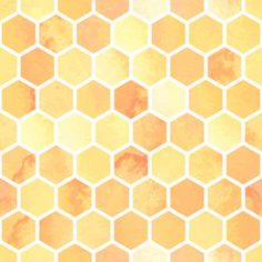 an orange and yellow hexagonal pattern with watercolor paint on it's surface