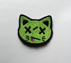 a green patch with a cat's face on it