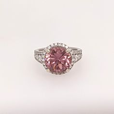 Presenting NNJ Designs' Summer Collection! This beautiful estate ring features a 5.07 carat round pink tourmaline gemstone with natural earth mined diamonds, all set in solid 14K gold. This Pink Tourmaline ring makes a lovely October birthstone gift for your loved ones! This ring is made with solid 14K Gold and natural Earth mined SI / G-H diamonds. As listed, this ring is ready to ship. If you're interested in purchasing this setting with a different center stone please message us! Pink Round Diamond Ring, Fine Jewelry, Fine Jewelry Pink Diamond Ring, Luxury Morganite Round Ring, Luxury Round Morganite Rings, Pink Round Rings With Halo Setting, Pink Halo Setting Round Ring, Pink Round Cut Halo Ring For Formal Occasions, Formal Pink Halo Ring With Round Cut, Formal Pink Diamond Ring