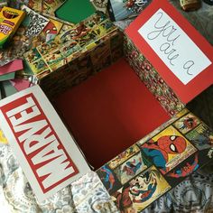 an assortment of comic books and candy are on the bed with a handwritten note