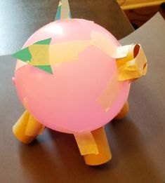 a pink ballon shaped like a pokemon pikachu sitting on top of a table