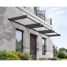 an exterior view of a modern house with wooden doors and windows