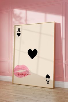 a pink room with an ace playing card wall decal on the wall and a lipstick kiss sticker