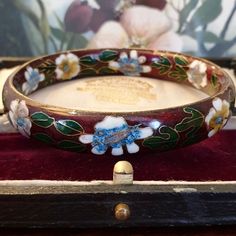 Vintage Bangle for Women - This is a gorgeous genuine Vintage Cloisonne Bangle, the beautiful Enamel Bangle is adorned with delicate flowers. Colours include burgundy, blue, purple, green, gold and yellow. The colours are so pretty together. The floral pattern continues internally inside the bangle. Please note this is a thick solid bangle and is therefore on the heavier side. The bangle is in Excellent Vintage Condition with no repairs or damage noted, just some minor age related wear as expect Vintage Enamel Bangle As A Gift, Vintage Enamel Bangle For Gift, Vintage Enamel Bangle As Gift, Vintage Enamel Bangle Gift, Vintage Flower Bracelets As Gift, Promise Rings Vintage, Cloisonne Jewelry, Bijoux Art Nouveau, Bridal Jewelry Vintage