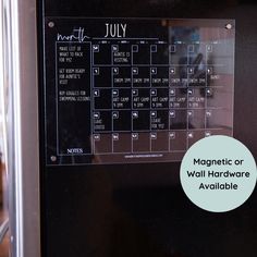 a magnetic calendar on the side of a refrigerator