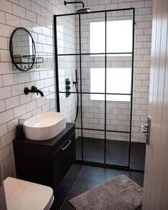 a bathroom with a toilet, sink and shower stall