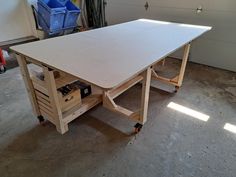 a workbench in a garage with tools on the table and storage drawers under it