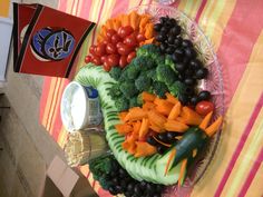 a plate full of vegetables and dips on a table