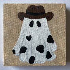 a painting of a cow with a hat on it's head and black spots