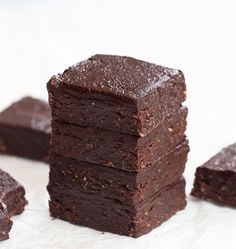 chocolate brownies stacked on top of each other with one piece cut out to show the inside