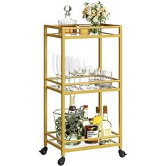 a gold bar cart filled with drinks and glasses