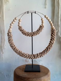 Handmade ceremonial Papua traditional Ornament from Indonesia. Made of white Shells . This Necklace is used in Papua for special rituals or ceremonies. Also is used as a payment between tribes. This beautiful piece is a very unique and powerful object in the Balinese culture. Size: L38, H38 high stand 47cm 0.8kg Perfect for elegant parties and all kind of Carnivals ! It can be wearied or used as a Decoration. You can buy with black metal stand You can buy without stand, you can hang it on the wa Traditional Beaded Beige Jewelry, White Artisan Jewelry For Ceremonial Occasions, Handmade White Jewelry For Traditional Ceremonies, Traditional Cream Necklace As A Gift, Artisan White Jewelry For Ceremonial Occasions, Traditional Cream Necklace For Gift, Ceremonial White Artisan Jewelry, Traditional Handmade Natural Jewelry, Traditional Natural Jewelry For Rituals