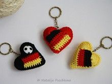 two crocheted heart shaped keychains sitting next to each other on a white surface