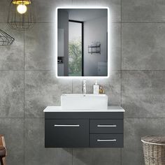 a bathroom with a sink, mirror and hanging lights on the wall next to it