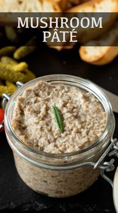 a jar filled with mushroom pate next to bread