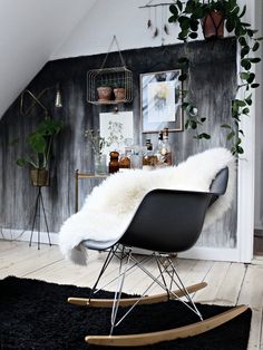 a black and white room with a rocking chair