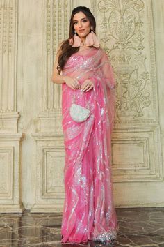 Pink padded blouse with jewel and stone embellished star patterns.
Components: 1
Pattern: Embroidered
Type Of Work: Jewel, stone
Neckline: U-neck
Sleeve Type: Sleeveless
Fabric: Polyester Satin,Net
Color: Pink
Other Details: 
Fitted shilouette
Attached lining
Closure: Back hook
Note: Saree worn by the model is not for sale
Occasion: Party,Cocktail - Aza Fashions Glamorous Organza Saree For Parties, Party Organza Saree, Glamorous Party Organza Saree, Glamorous Georgette Blouse Piece, Glamorous Party Saree With Pearl Embroidery, Organza Blouse With Mirror Work For Party, Glamorous Organza Blouse Piece For Party, Embellished Fitted Saree, Glamorous Festive Blouse