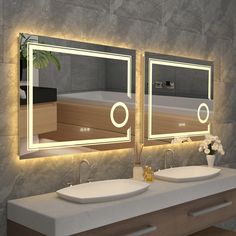 two sinks in front of a large mirror with lights on the sides and below them