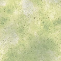 a green and white textured background with black dots