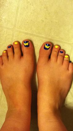 two feet with yellow and blue designs on them