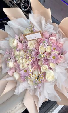 a bouquet of flowers sitting on top of a car dashboard