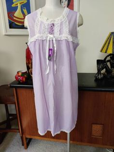 This is a new old stock night gown with tags in a pretty mauve colour with contrasting white lace trim by St Mark label probably 70s. Of course it is unworn and in very good condition is marked a vintage size 16 to fit 95cm bust 75cm waist 100cm hips according to the label Actual measurements are Bust 108cm Length 92cm Fitted Lace Trim Nightgown For Sleepover, Lace Trim Nightgown For Sleepover, Lace Trim Dress For Sleepover, Sleeveless Purple Dress For Sleepover, Sleeveless Lace Nightgown For Home, Purple Lace Sleepwear For Loungewear, Feminine Sleeveless Sleepwear With Lace Patchwork, Sleeveless Summer Sleepwear With Contrast Lace, Fitted Sleeveless Sleepwear With Lace Patchwork