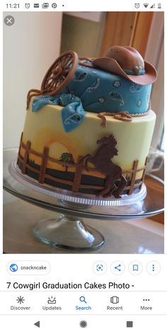 a cake that is on top of a glass platter with a horse and cowboy hat on it