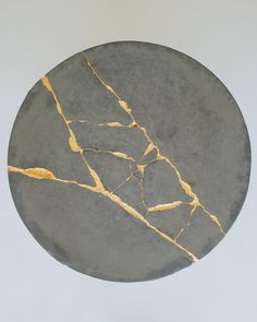 a black and gold marble plate on a white background