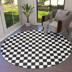 a black and white checkered area rug in a living room with a large window