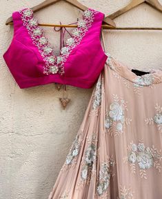 This exquisite Rani Pink and Tan Embroidered Lehenga Set with Ruffle Dupatta is a vision of elegance, combining the charm of traditional craftsmanship with modern style. Made from georgette fabric, the tan umbrella lehenga features intricate sequin and thread work floral motifs, beautifully accentuated by a wide, shimmering gota border in gold and vibrant pink, adding a regal touch to your look. Paired with a striking rani pink raw silk blouse, it dazzles with its plunging neckline adorned with Elegant Pink Lehenga With Gota Work, Elegant Pink Choli With Mirror Work, Pink Wedding Blouse Piece With Mirror Work, Pink Wedding Blouse With Mirror Work, Pink Georgette Blouse Piece With Gota Work, Pink Georgette Choli With Intricate Embroidery, Navratri Pink Embellished Blouse Piece, Navratri Embellished Pink Blouse Piece, Pink Embellished Blouse Piece For Navratri