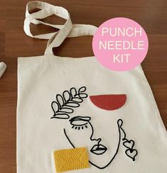 a tote bag with an image of a woman's face on it and the words punch needle kit