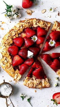 there is a pie with strawberries and nuts on it