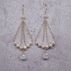 Pearl White Chandelier Earrings Made Of Pearl For Gifts, Handmade Pearl Chandelier Earrings Gift, Natural Stone Dangle Pearl Earrings, Gift Pearl Charm Dangle Chandelier Earrings, Pearl White Chandelier Earrings With Pearl Charm, Elegant Gold Crystal Earrings With Moonstone, Pearl White Chandelier Earrings With Pearl Charm As Gift, Elegant Pearl Drop Earrings With Natural Stones, Elegant Natural Stone Pearl Drop Earrings