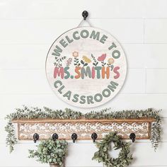 two potted plants and a welcome sign on a wall