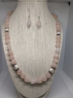 "This set is very pretty. It is made of 10mm rose quartz round beads, 6x10 mm dog bone rose quartz beads, 4mm bicone clear crystals and approx. 8 x 10 genuine white cultured pearls. The necklace measures 22\" (inches) end to end. It is finished with a silver plated toggle clasp.  The earrings are made of the rose quartz dog bone bead with 4mm crystals. It hangs 1. 1/16 of an inch just below the ball of the silver plated French wire  The rose quartz is a very pretty pale pink which I was having trouble trying to get with my camera. I ship USPS so that your package will arrive safe and sound in only a few days!  Satisfaction is always guaranteed!  You can email me at  lynnsattic@gmail.com or convo me with any suggestions, questions, ideas or comments.  I'm always very happy to hear from you! Elegant Jewelry With 8mm Beads For Mother's Day, Elegant 8mm Beads Jewelry For Mother's Day, Elegant 8mm Beaded Jewelry For Mother's Day, Elegant Rose Quartz For Jewelry Making, Pink Pearl Jewelry With 8mm Beads, Elegant Beaded Rose Quartz Jewelry, Elegant Rose Quartz Beaded Jewelry, White Rose Quartz Jewelry For Jewelry Making, Elegant Rose Quartz Round Beaded Jewelry